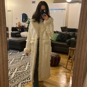 White faux leather coat, fur lined and fur trim on outside. Wore once.